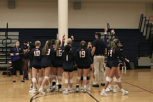 The LS Girls Volleyball team gathers with Coach Falcone. Photo courtesy of Sophie Ward.